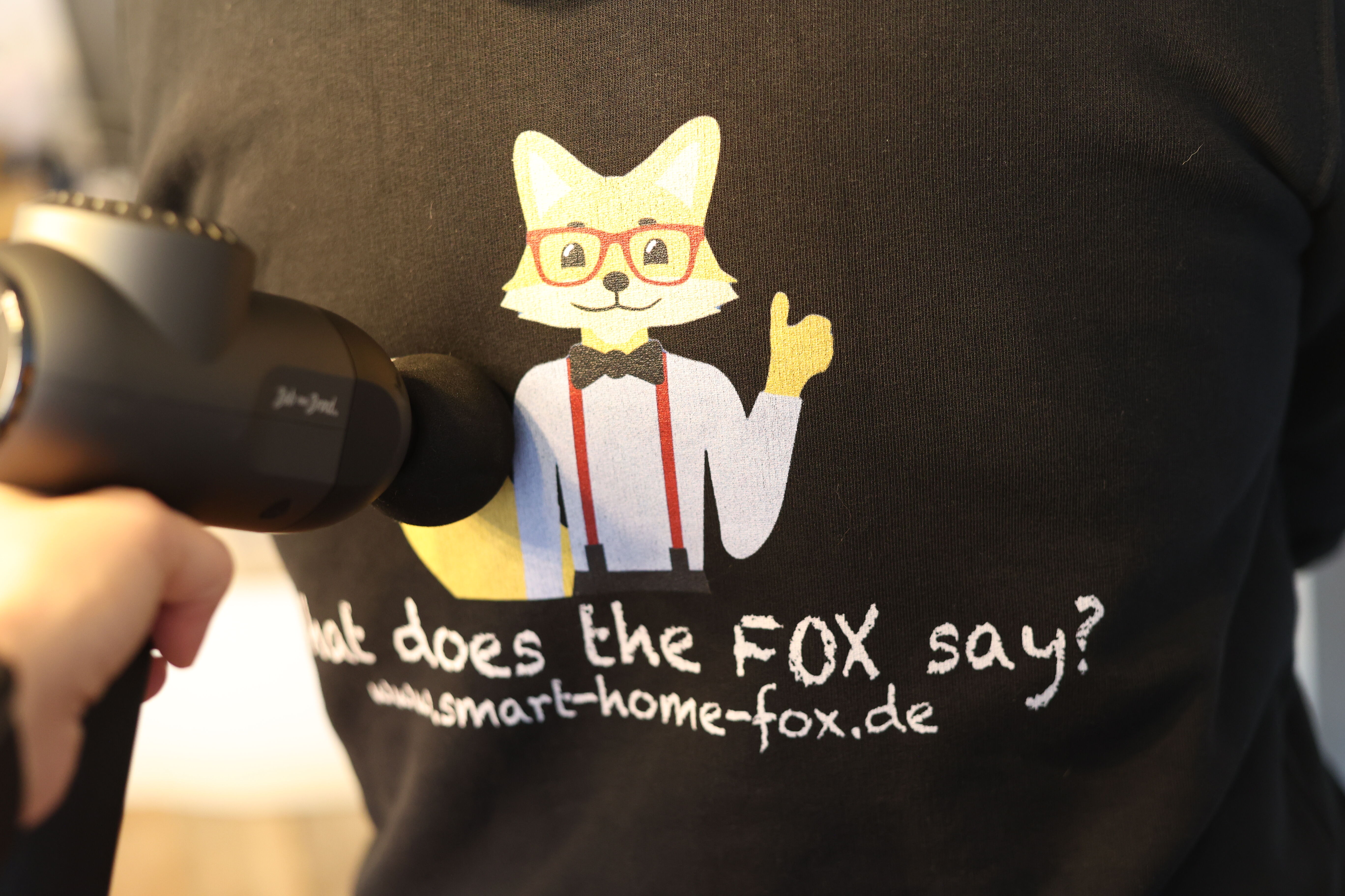 Massagepistole am Rücken